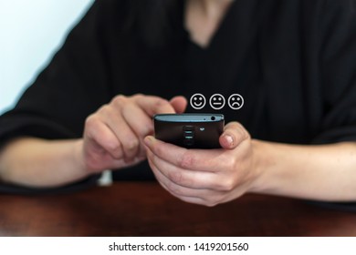 Woman Using Phone For Service Rating And Costumer Satisfaction