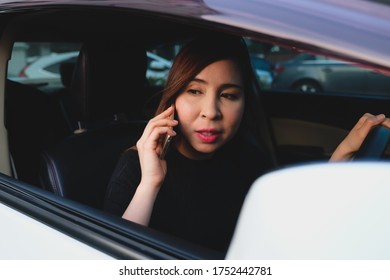 Woman Using Phone While Driving The Car And Watting Trafic Jam. Multitasking, Drive