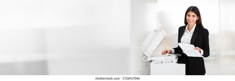 Woman Using Photocopy Machine In Office. Printer And Copier