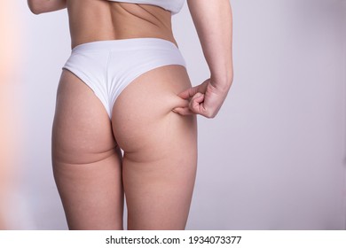 A woman using pinch test as one of the methods for measuring body fat stock photo
