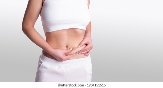 A Woman Using Pinch Test As One Of The Methods For Measuring Body Fat On Belly