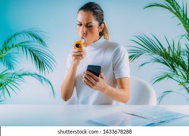 Woman Using Portable Spirometer And A Smart Phone App