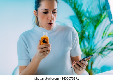 Woman Using Portable Spirometer And A Smart Phone App