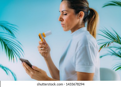 Woman Using Portable Spirometer And A Smart Phone App