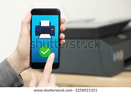 Woman using printer management application on smartphone indoors, closeup and space for text. Image on device screen.