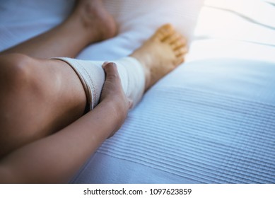 Woman Using Put On Elastic Bandage With Legs Having Knee Or Leg Pain,Selective Focus