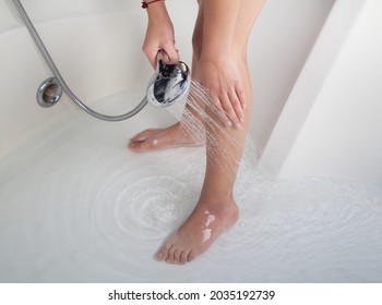 Woman using  shower in the bathroom. Woman legs.  - Powered by Shutterstock