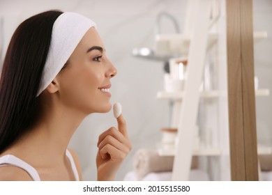 Woman Using Silkworm Cocoon In Skin Care Routine At Home