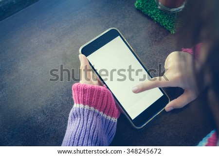 woman using smart phone with blank empty screen.
