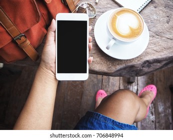 Woman Using Smart Phone And Coffee Cup With Bag