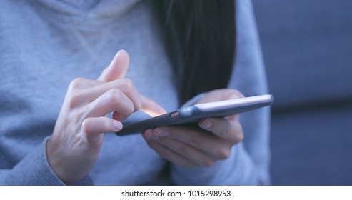 Woman using smart phone in the evening 