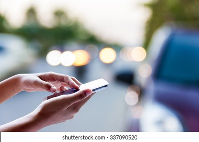 Woman Using Smart Phone For Help On The Street .