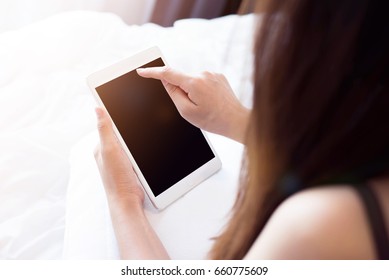 Woman Using Smart Phone And Ipad On Bed, Person Using The Digital Tablet In Living Room, Typing On A Tablet Or Ipad, Relaxing With Ipad. Black Screen.