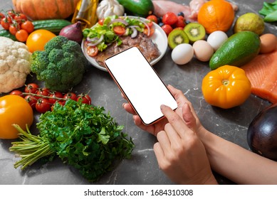 Woman Using Smart Phone In Kitchen, Template For Your Own Design