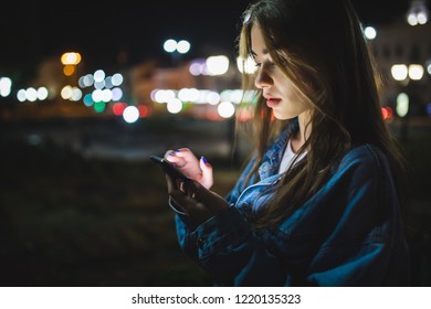 Woman Using Smart Phone Mobile In The City At Night