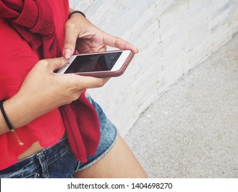 Woman using smart phone on hand - Shutterstock ID 1404698270