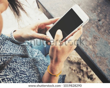 Woman using smart phone on hand