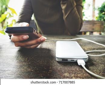 Woman Using Smart Phone With Power Bank