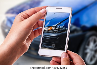 A Woman Using A Smart Phone To Take A Photo Of The Damage To Her Car Caused By A Car Crash