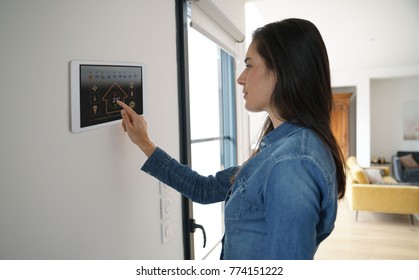 Woman Using Smart Wall Home Control System 