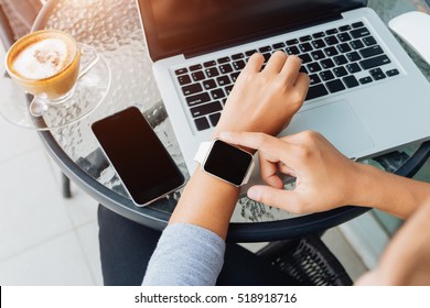 woman using smart watch in coffee shop, modern city lifestyle