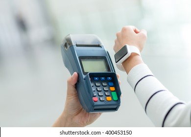 Woman Using Smart Watch To Pay By NFC Technology