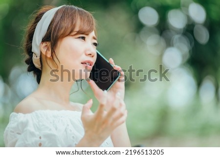 A woman using a smartphone (angry, trouble)