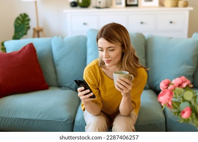 Woman using smartphone and drinking coffee in the morning - Powered by Shutterstock