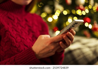 Woman using smartphone during Christmas - Powered by Shutterstock