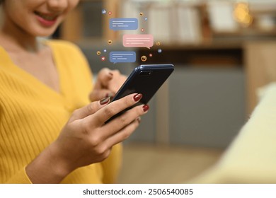 Woman using smartphone with floating chat bubbles and social media icons, messaging or interacting in social media - Powered by Shutterstock