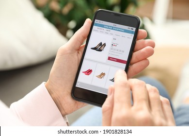 Woman using smartphone for online shopping indoors, closeup
