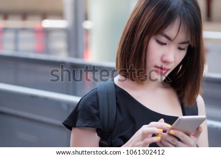 woman using smartphone; portrait of asian woman using smartphone, concept of internet connection, communication, smartphone device, online shopping; asian young adult woman model