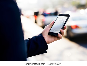 Woman using a smartphone with a screen mockup