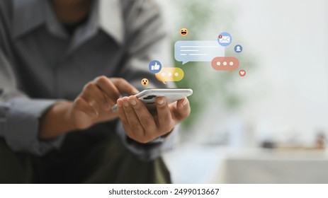 Woman using smartphone with social media icons and notification badges. Communication and technology concept. - Powered by Shutterstock