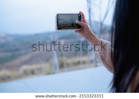 Woman using smartphone take a photo at Khao Kho, Thailand