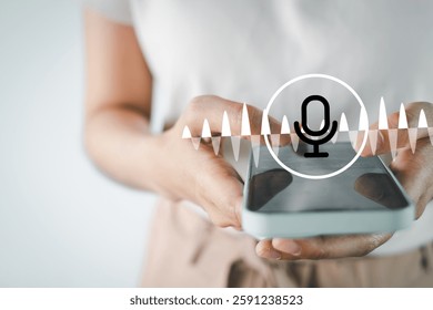 Woman using smartphone with voice assistant and sound wave icon, representing artificial intelligence,speech recognition,voice search, smart technology,digital communication,and hands-free AI control.