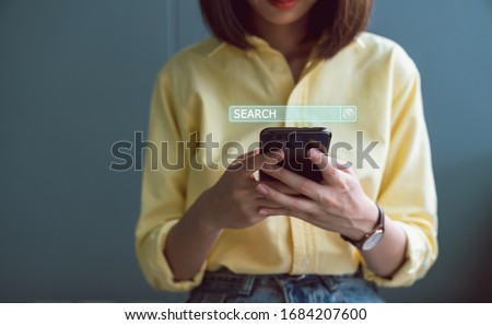 Woman using smartphones and searching browsing Internet button on virtual on screen mobile.