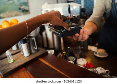 Woman Using Snap Scan On Cellular Device To Purchase Coffee From Funky Cafe 