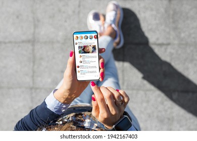 Woman using social media microblogging app on her phone