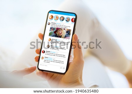 Woman using social media microblogging app on phone