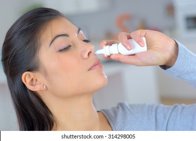 Woman Using A Spray For Blocked Nose