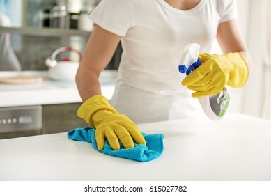 Woman using spray for cleaning