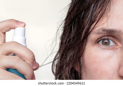 Woman Using Spray On Wet Hair Isolated.smiling Girl With Wet Hair Long Bangs Chaotic On Face Hold In Hand Bottle With Oil Spray Keratin For Extra Shine Healthy Structure.parts Of Face Closed Eye Relax