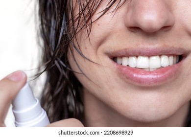 Woman Using Spray On Wet Hair Isolated.smiling Girl With Wet Hair Long Bangs Chaotic On Face Hold In Hand Bottle With Oil Spray Keratin For Extra Shine Healthy Structure.parts Of Face Closed Eye Relax