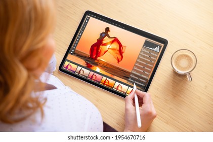 Woman using stylus pen for image editing on tablet computer