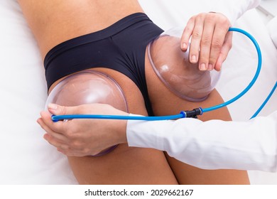 Woman using suction cup pump up on her butt to lift it up. - Shutterstock ID 2029662167