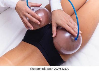 Woman using suction cup pump up on her butt to lift it up.