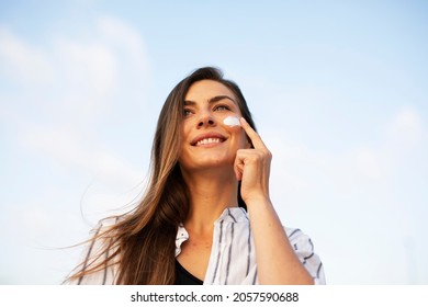 Woman Using Sunscreen Cream. Beautiful Girl With Sun Protection Cream.