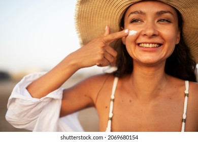 Woman using sunscreen cream. Beautiful girl with sun protection cream.	