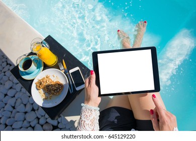 Woman using tablet by the pool - Powered by Shutterstock